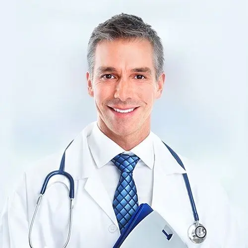 Smiling chiropractor with model of spine.