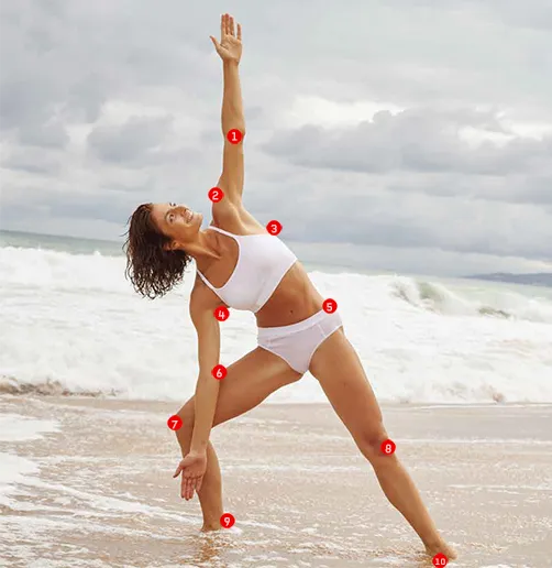 woman on beach in a yoga pose