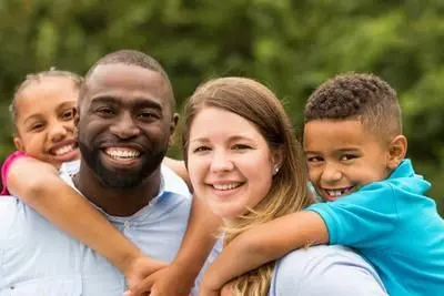 Smiling interracial family of four