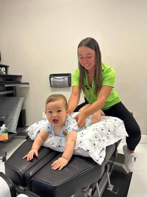 Chiropractor providing gentle adjustment to baby at Dr. Gena Chiropractic in Plantation, Florida.