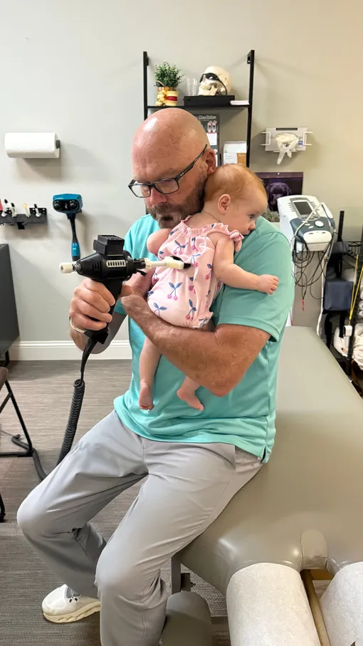 Dr. McDaniel performing a gentle adjustment on an infant