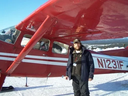 Dr. Walker standing by plane