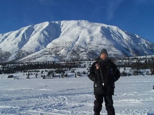 Dr. Walker in front of snowy mountain