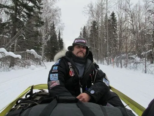 Dr. Walker riding in sled