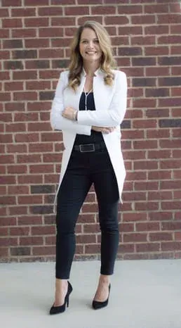 doctor in front of brick wall