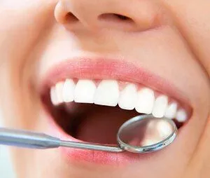 dental mirror in woman's mouth reflecting tooth-colored filling under top tooth, cosmetic dentistry Lake Worth, FL dentist Greenacres, FL