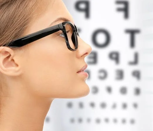 lady wearing glasses infront of eyechart