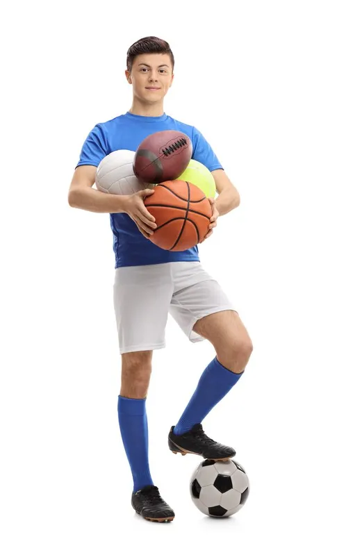 Teen balancing sports balls