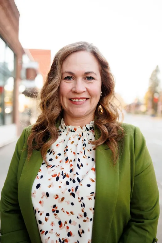 A woman with long wavy brown hair