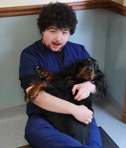 boy holding dog