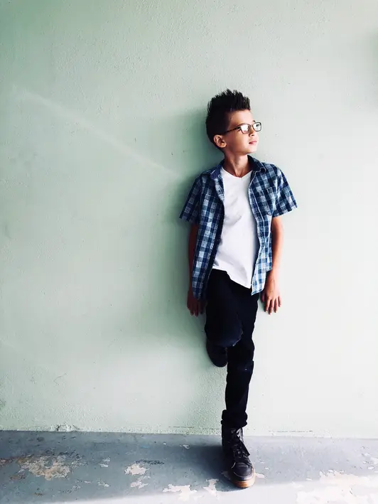 boy standing at wall