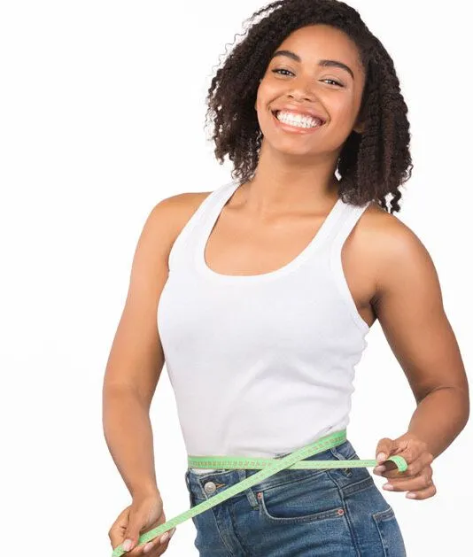 woman holding a tape measure around her waist