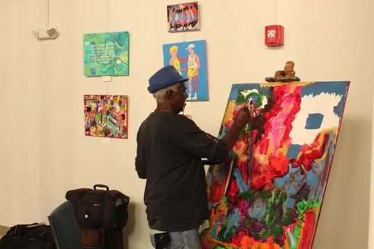 Artist painting on a standing easel 