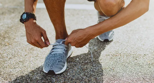 Man Tying Running Shoes