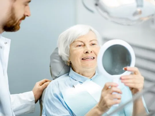 Dentist fixed Dental Implants Birmingham MI for an old women