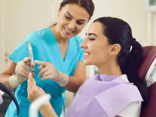 Dentist showing  Beautiful Girl Dental Implants Royal Oak MI