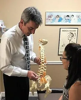 Dr. Gregg Krown explaining chiropractic care to a patient.