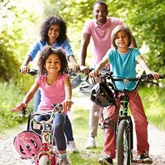 family with kids outdoors riding bikes, General Dentistry Cypress, TX