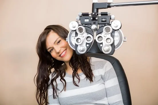 woman getting an eye exam from her eye doctor