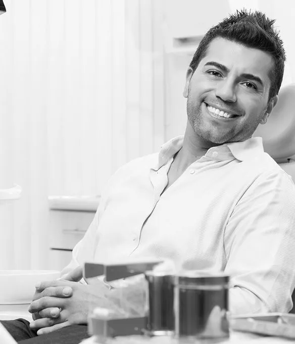 man sitting in dental chair smiling