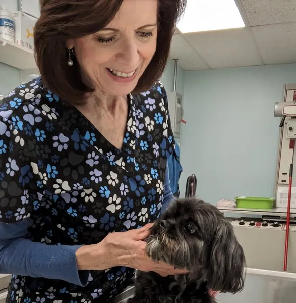 Gina holding dog on table