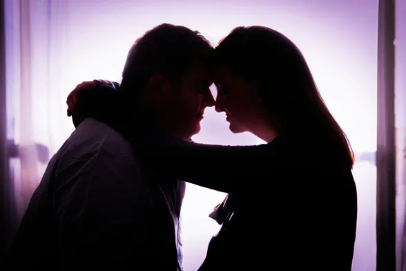 Person sitting in front of an audio mixer