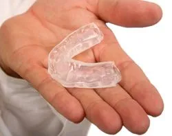 hand holding dental nightguard in palm, custom nightguards and mouthguards Brookline, MA dentist