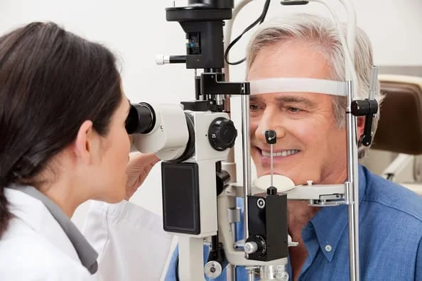 man receiving an eye exam from his eye doctor in Kansas City