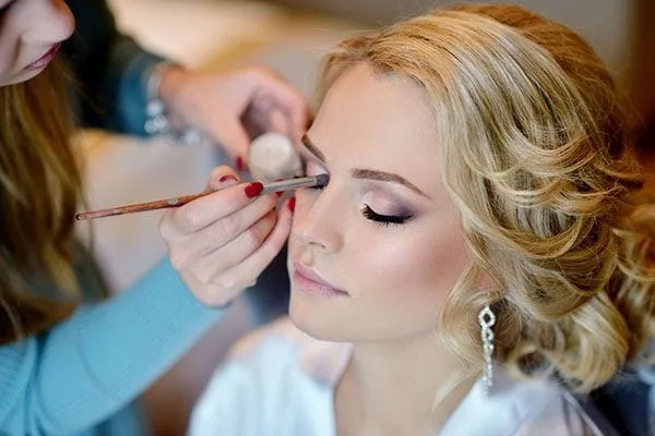Image of a female having her makeup done