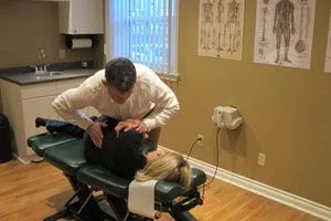 doctor cracking patients lower back