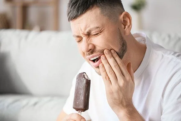 guy in pain with eating icecream