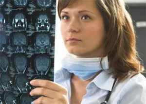 medical professional looking at x-rays of someone's brain