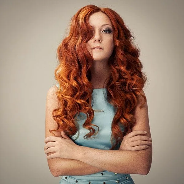 Image of a female with long wavy red hair