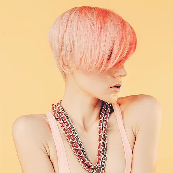 Image of a female with a short pixie cut dyed pink