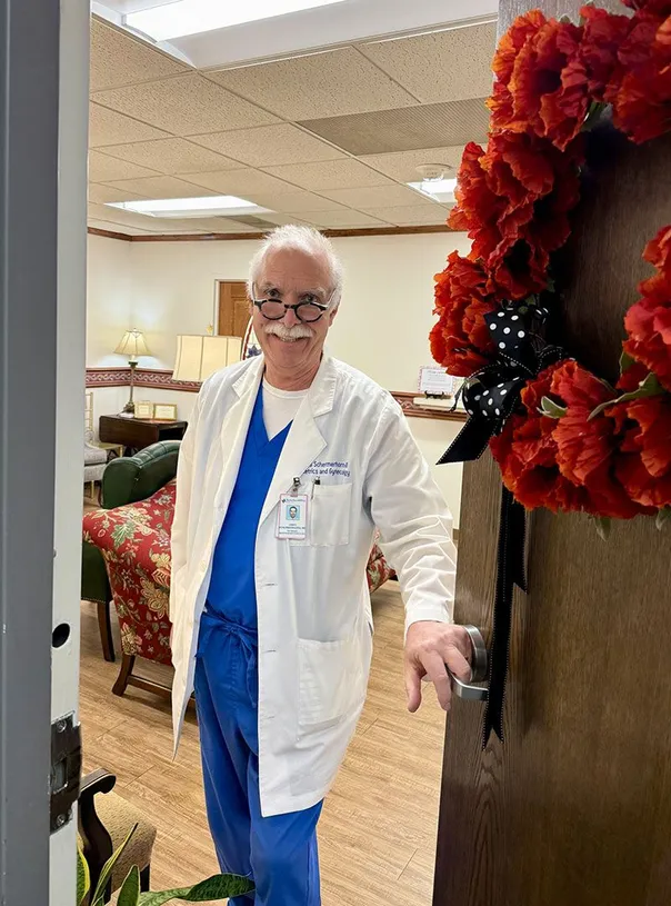 doctor holding front door open