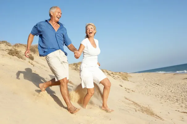 happy elderly couple at the beach