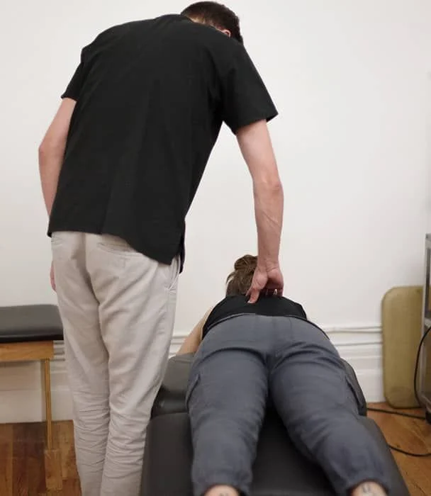 chiropractor checking patient for symptoms and signs of sciatica