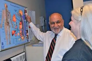 Chiropractor Hapeville explaining chiropractic care to a new patient.