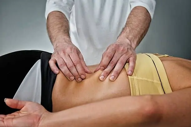 Chiropractor doing Myofascial Release Technique to the patient.