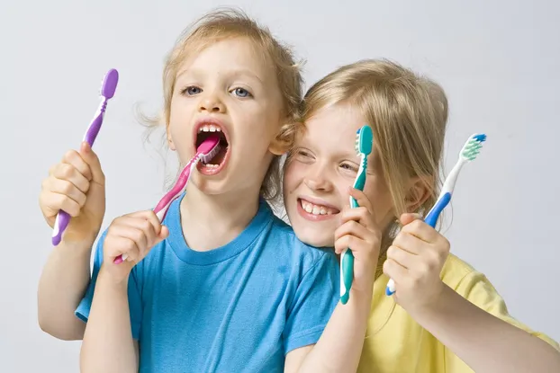 Photograph of laughing children with toothbrushes, Family Dentistry, Waterloo, ON