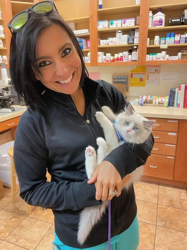 A woman holding a cat