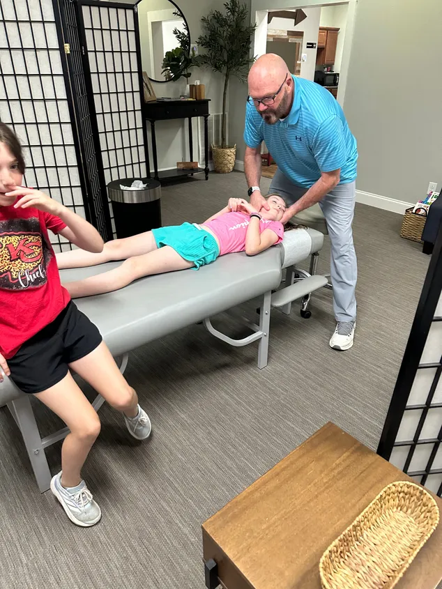 Dr. McDaniel giving a child a pediatric adjustment