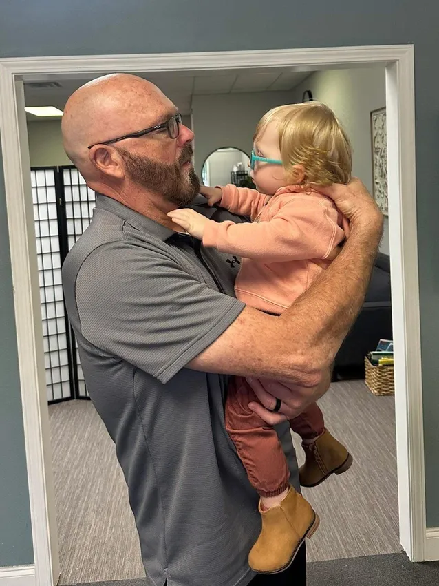 Dr. McDaniel performing a pediatric adjustment on a young toddler
