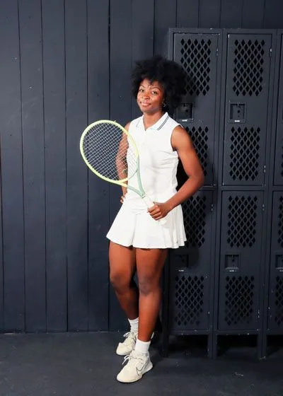 Dr. Ebo's daughter taking pictures with tennis racket
