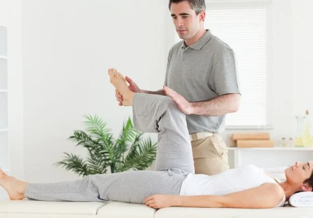 A Man Stretching womans leg