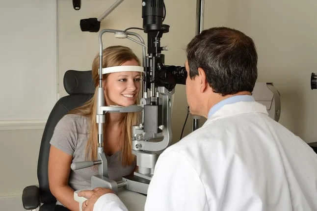 child being examined by her optometrist 