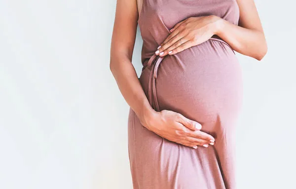 woman holding pregnant belly