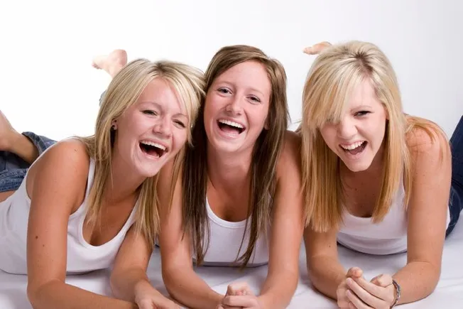 girls laying down and laughing