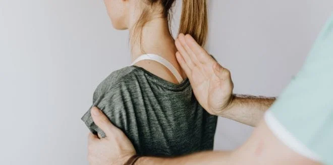 A man doing spine treatment to a woman
