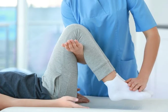 Chiropractor treating a patient with knee pain